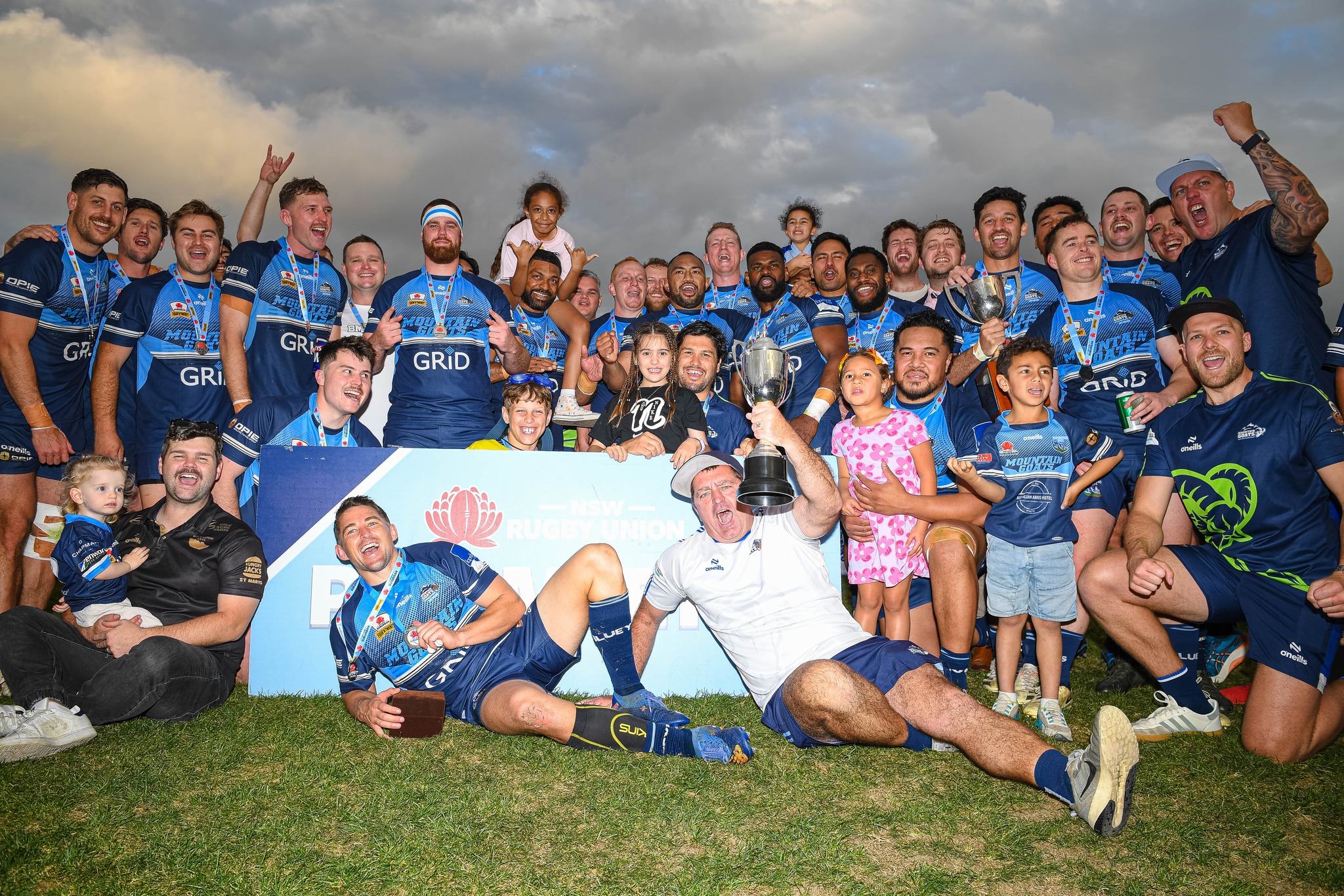 Blue Mountains Rugby players celebrating with a premiership trophy